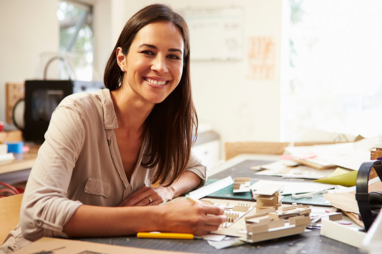 female architect working on house model